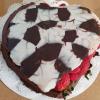 Valentine cake with chocolate candy lid and fresh berries
